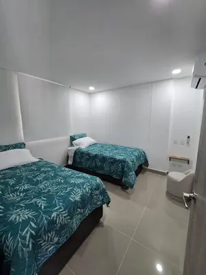 a hotel room with two beds and a toilet at OceanDrive509 in Cartagena de Indias
