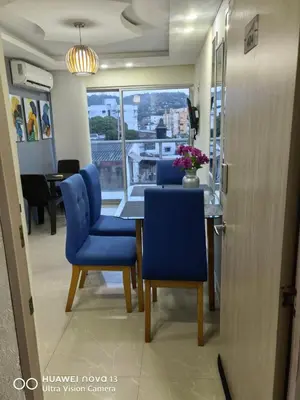 a dining room with blue chairs and a table at Lujoso Apartamento en Cartagena in Cartagena de Indias