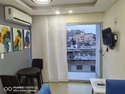 a room with a window with a view of a city at Lujoso Apartamento en Cartagena in Cartagena de Indias