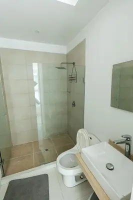 a bathroom with a shower and a toilet and a sink at Luxury House Cartagena Private pool in Cartagena de Indias