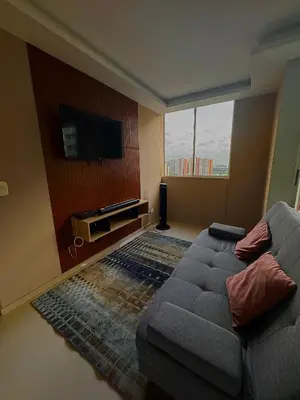 a living room with a couch and a flat screen tv at CARIBE STAY - Apto in Barranquilla