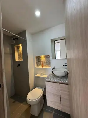 a bathroom with a toilet and a sink at CARIBE STAY - Apto in Barranquilla