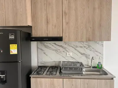 a kitchen with a sink and a stove and a refrigerator at Beach Lotus 1203 in Cartagena de Indias