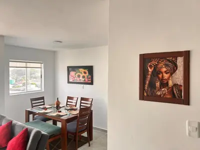 a dining room with a table and a painting on the wall at Beach Lotus 1203 in Cartagena de Indias