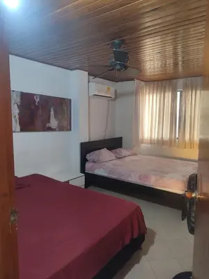 a bedroom with two beds and a ceiling at Oasis del Manglar in Cartagena de Indias