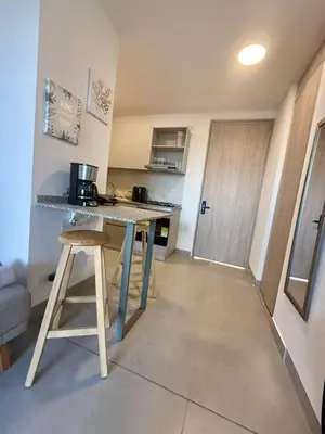 a kitchen with a table and a counter top at BRISA MARINA, Santa Marina Condominio in Santa Marta