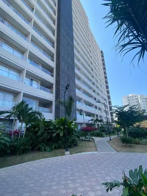 a large apartment building with palm trees in front of it at BRISA MARINA, Santa Marina Condominio in Santa Marta
