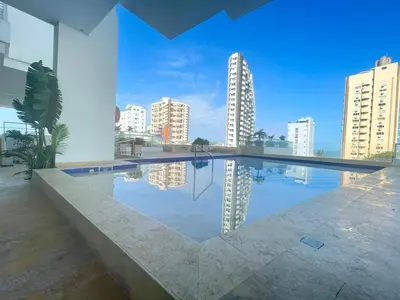 a large swimming pool in a building with buildings at Apartamento a pasos del mar y centro en Cartagena, piscina sauna & turco in Cartagena de Indias