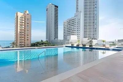 a swimming pool in a city with tall buildings at Apartamento a pasos del mar y centro en Cartagena, piscina sauna & turco in Cartagena de Indias