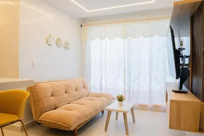 a living room with a couch and a large window at Luxury apartment with ocean view 15th floor in Cartagena de Indias