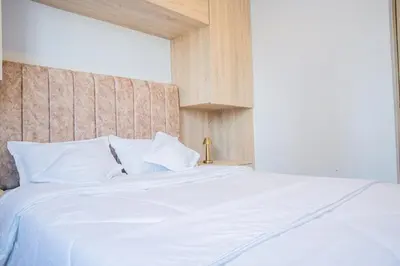 a bedroom with a white bed with a wooden headboard at Luxury apartment with ocean view 15th floor in Cartagena de Indias