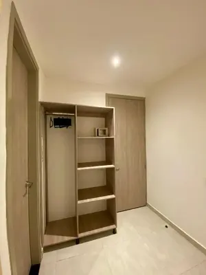 a room with a book shelf and a closet at BQ84 Urban Hotel in Barranquilla