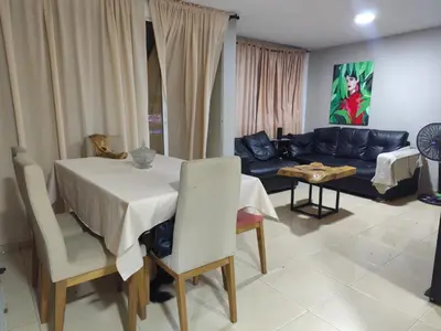 a living room with a table and a couch at Cómoda habitación cerca de la via 40 Carnaval Barranquilla in Barranquilla