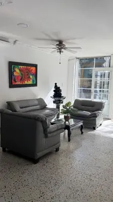 a living room with two couches and a ceiling at hotel hispanoamericano in Barranquilla