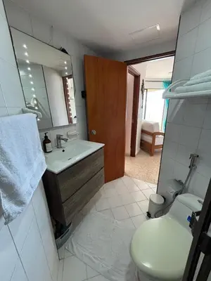 a bathroom with a sink and a toilet and a mirror at Apartamento con la mejor ubicación y vista al mar in Cartagena de Indias