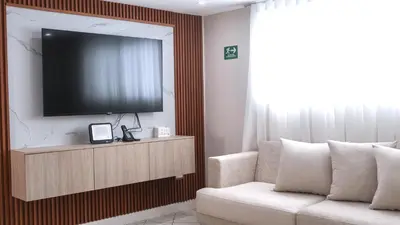 a living room with a television and a couch at Margarita 93 in Barranquilla