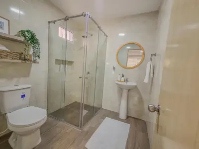 a bathroom with a shower and a toilet and a sink at Margarita 93 in Barranquilla