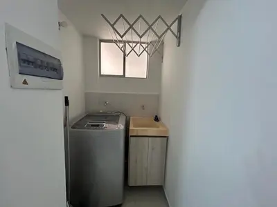 a laundry room with a washing machine and a window at Serena Del Mar Apartment in Cartagena de Indias