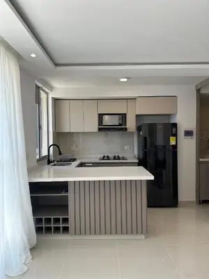 a kitchen with a sink and a refrigerator at Apartamento a 5 min del cc Buena Vista in Barranquilla