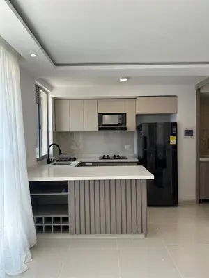 a kitchen with a sink and a refrigerator at Apartamento a 5 min del cc Buena Vista in Barranquilla
