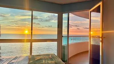 a bedroom with a view of the ocean from a window at Vive Cartagena magica frente al mar y lago in Cartagena de Indias