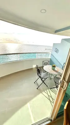 a balcony with a table and chairs on a boat at Vive Cartagena magica frente al mar y lago in Cartagena de Indias