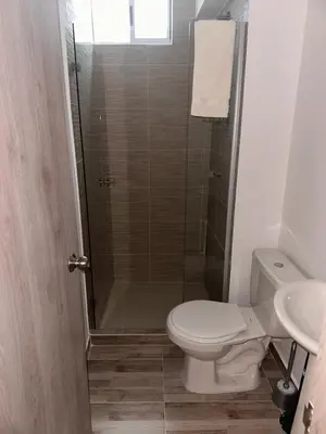 a bathroom with a shower with a toilet and a sink at Luxury apartment in Barranquilla