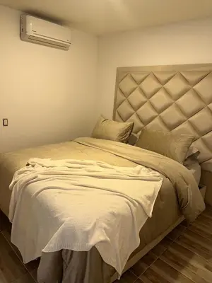 a bedroom with a large bed with a large headboard at Luxury apartment in Barranquilla