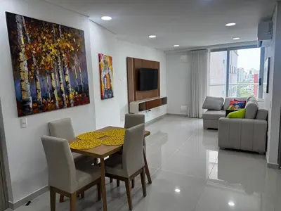 a living room with a table and chairs and a tv at NEW Premium 1BR Apartment in the Best Area in Barranquilla