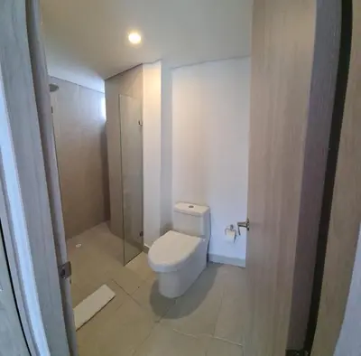 a white bathroom with a toilet and a shower at Oceani Tower Cielo Mar Apartment in Cartagena de Indias