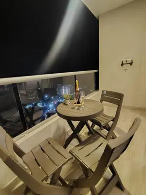 a table and chairs on a balcony with a view of a city at Apartamento de lujo en Santa Marta in Santa Marta