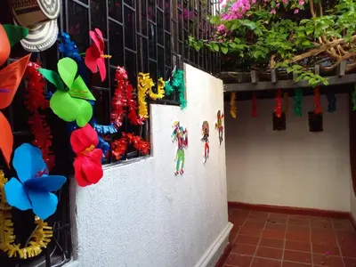 a wall with decorations on it with flowers on it at Ideal house for Carnival in Barranquilla