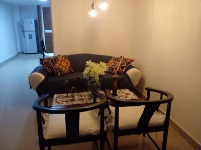 a living room with a couch and two tables at Ideal house for Carnival in Barranquilla