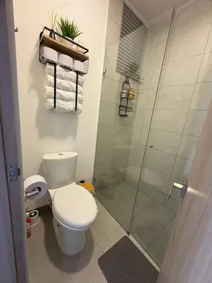 a bathroom with a toilet and a shower at Cardona Suite Santa Marina Santa Marta in Santa Marta