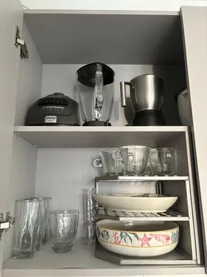 a shelf with bowls and other kitchen utensils at Cardona Suite Santa Marina Santa Marta in Santa Marta