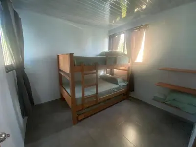 a bedroom with two bunk beds in a room at El Castillo in Moñitos