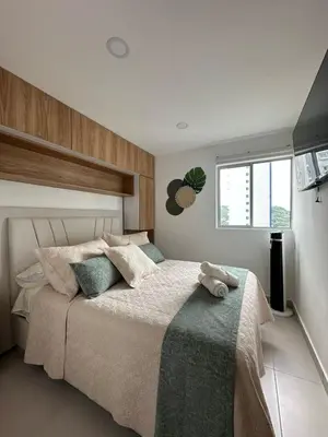 a bedroom with a large bed with pillows at Caribbean Deluxe Apartment Walk to Beach WiFi in Cartagena de Indias