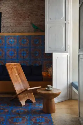 a wooden chair and a table in a room at NOK Luxury Colonial Villa 6BR with Pool Staff & Breakfast at Getsemani in Cartagena de Indias