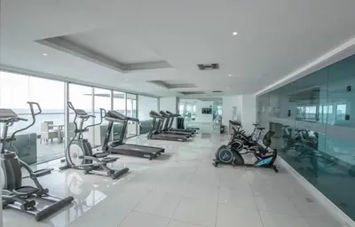 a gym with several exercise bikes in a room at 3br Apartment in front of the beach 8 paxs in Cartagena de Indias