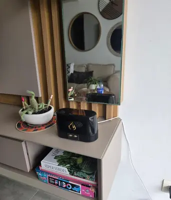 a mirror on top of a shelf with books at Luxury Oceanfront Apartment Spiaggia 2BR 3BA Playa azul Cartagena in Cartagena de Indias