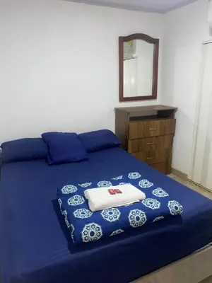 a bedroom with a blue bed with towels on it at Apartaestudio Equipado a Menos de 100m de la Playa in Cartagena de Indias