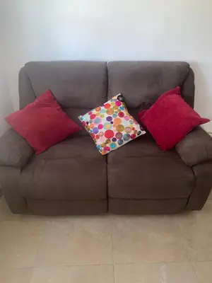 a brown couch with four pillows on it at Apartaestudio Equipado a Menos de 100m de la Playa in Cartagena de Indias