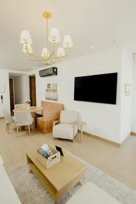 a living room with a table and a tv on a wall at Now booking April! Walking to City Center 2 BDRM in Cartagena de Indias