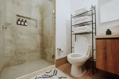 a bathroom with a toilet and a glass shower at Cartagena View perfect for couples beach & walk in Cartagena de Indias
