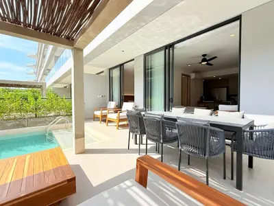 a dining room with a table and a swimming pool at 2-Bedroom Apartment with Private Pool - Morros Kai in Cartagena de Indias