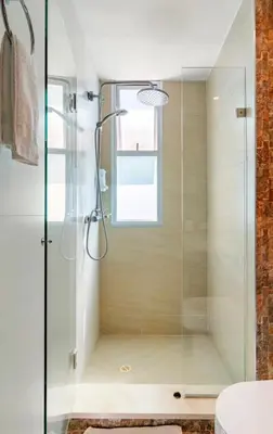 a glass shower in a bathroom with a window at Espectacular Apartamento salida directa a playa in Cartagena de Indias