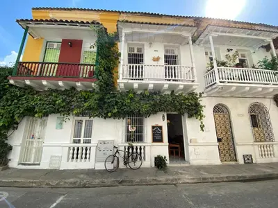 a bike parked in front of a white building at Cozy apartment Old City in Cartagena de Indias