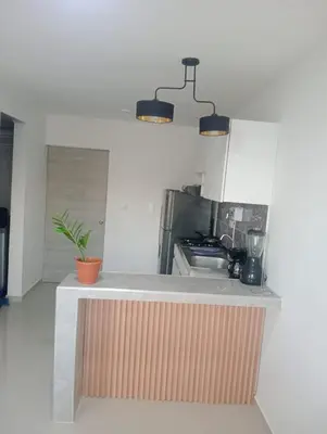 a kitchen with a counter with a sink and a stove at Modern & Cozy Apartment Near the Beach in Cartagena de Indias