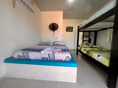 a bedroom with two beds in a room at Costa Azul Isla Fuerte in Isla Fuerte