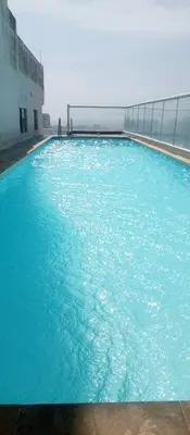 a large pool of blue water in a building at Apartamento 3 Habitaciones con Piscina cerca de las Playas de Cartagena in Cartagena de Indias